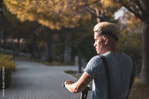 A gay boy stops his scooter to think about his problems because he has depression. Anxiety.