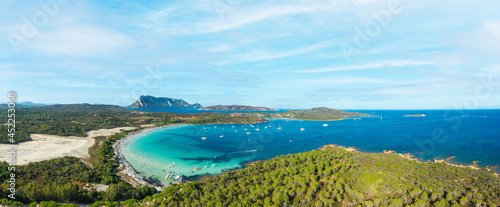 View from above, stunning aerial view of Cala Brandinchi beach with its beautiful white sand, and crystal clear turquoise water. Tavolara island in the distance, Sardinia, Italy.