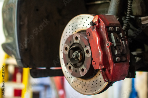 Red brake caliper of performance car.