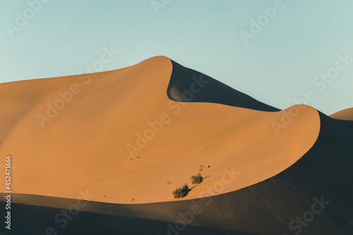 The sunset view of the dunes in deserts in Dunhuang, China.