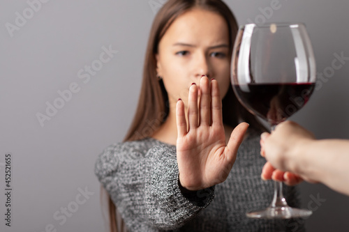 refuse alcohol, stop liquor, teenager shows a sign of rejection of wine with her hand