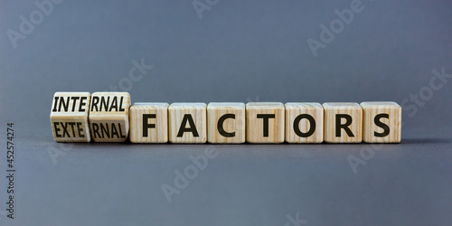 External or internal factors symbol. Turned wooden cubes and changed words external factors to internal factors. Beautiful grey background, copy space. Business, internal or external factors concept.