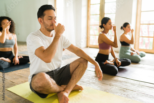 Latin people taking a meditation class