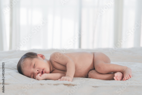 little newborn infant baby sleeping on bed