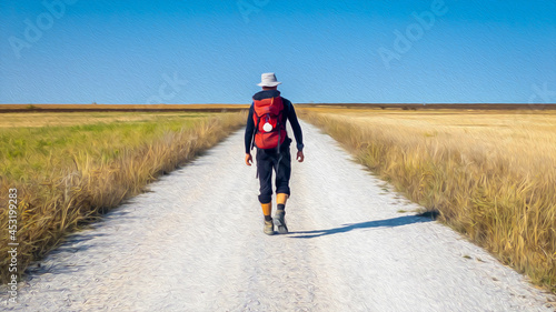Pilgrim walking on the Meseta along Way of St James Pilgrimage Trail Camino de Santiago