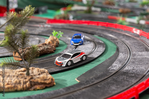 View of electric slot cars on the toy race track ready to play