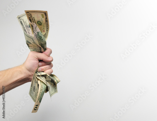 Hand holding a wad of cash