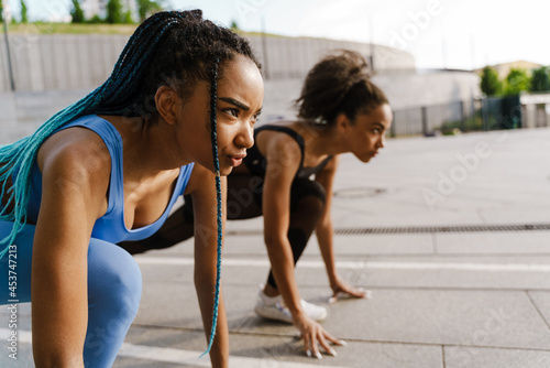 Two young fit african women in sportswear jogging