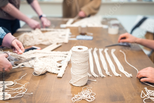 macrame workshop - woman weaving macrame panels for home decor