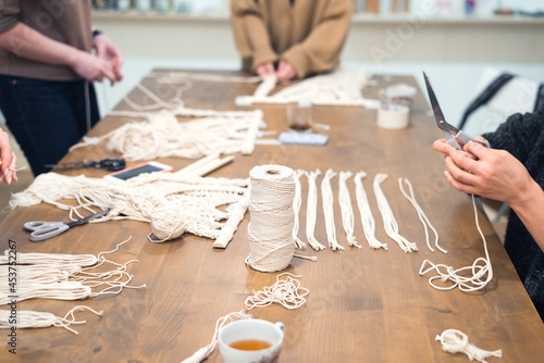 macrame workshop - woman weaving macrame panels for home decor