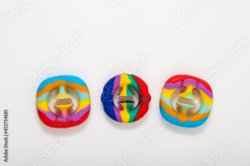Three children's toys that develop fine motor skills. Fashionable silicone toys Snapperz on light background. Selective focus, place for text