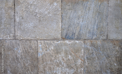 wall of brown and blue ashlar and mortar stones