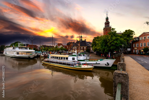 Leer, east frisia. View from Leda river on City Hall in Dutch Renaissance style , old Weigh House in Dutch classical Baroque style, Tourist Harbor and Bridge of Erich vom Bruch at sunset