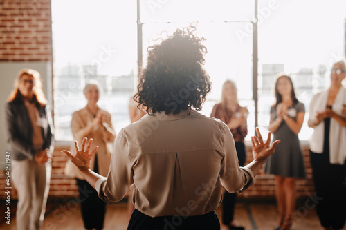 African american female empowering other colleagues in workplace