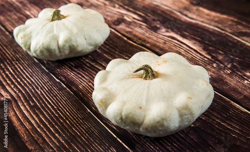 patison pumpkin squashed on dark kitchen table, whole bio raw vegetable brom village gardening