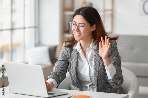 Young woman having interview online at home