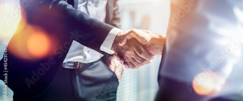 Businessman handshake for teamwork of business merger and acquisition,successful negotiate,hand shake,two businessman shake hand with partner to celebration partnership and business deal concept