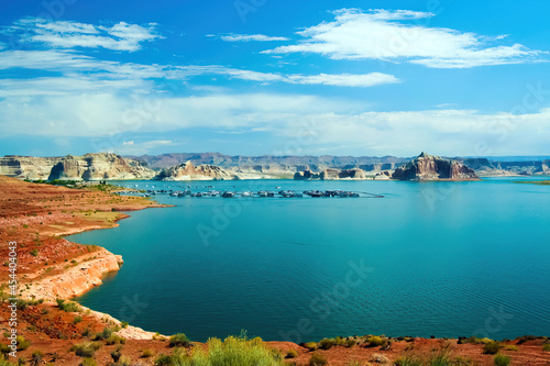 View on tranquil lake with dry arid landscape against blue summer sky with clouds - Lake Mead, USA