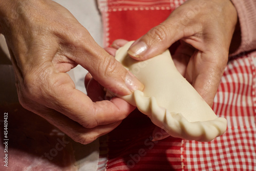 woman's hand preparing Argentine repulgue empanadas