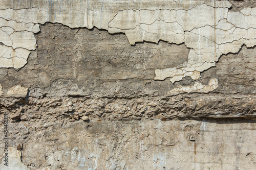 cracked white concrete wall under direct sun light full frame background and texture