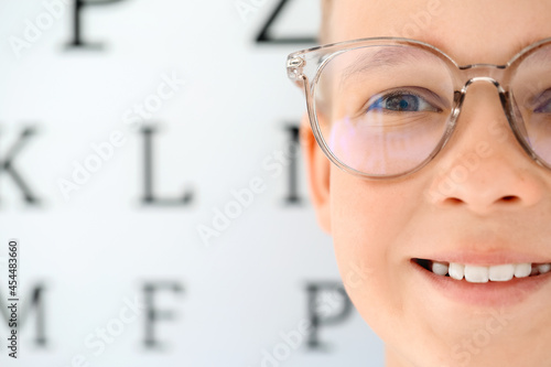 Little boy wearing glasses at ophthalmologist's office, closeup