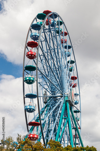 Colorful ferris wheel in amusement park in summer