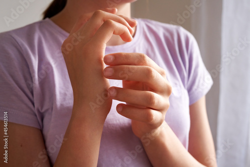 Teenage girl practicing EFT - emotional freedom technique - tapping on karate chop point