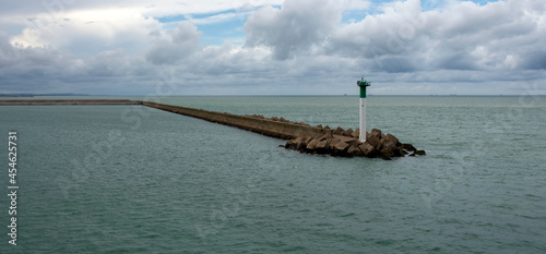 Breakwater with lighthouse on French coast - Calais, France