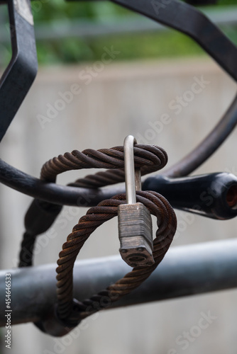 Padlock on a cable securing a handwheel for a canal sluice gate.