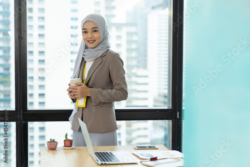 Asian Muslim businesswoman in hijab head scarf in the modern office. businesspeople, diversity and office concept