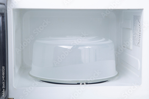 Plastic lid for the microwave oven. Comfortable use of a microwave oven.