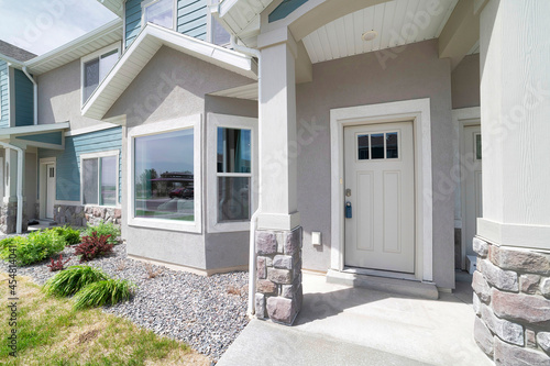 Townhouse exterior with white front door and bay windows