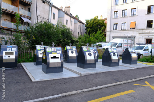 GENEVA, Switzerland - August 2021: metal waste containers for separate sorting public waste in courtyard of apartment building in Switzerland, concept of recycling and disposal of household waste