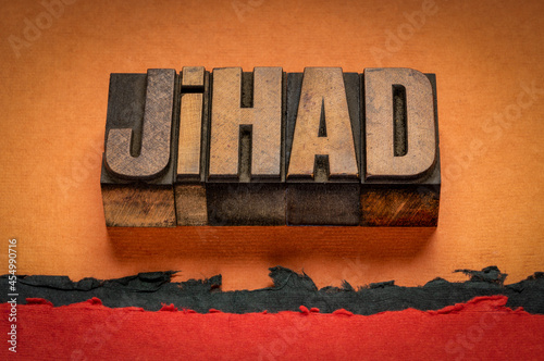 jihad, a struggle or fight against the enemies of Islam, word abstract in vintage letterpress wood type against abstract desert paper landscape