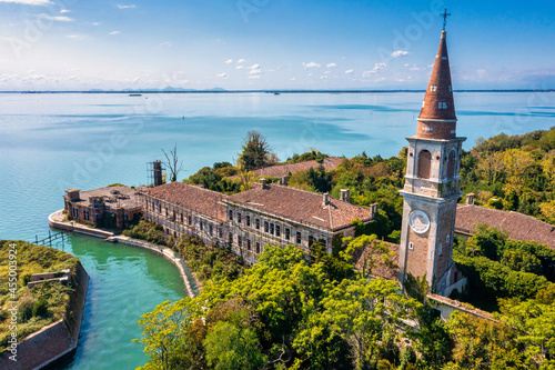 Aerial view of the plagued ghost island of Poveglia in the Venetian lagoon, opposite Malamocco along the Canal Orfano near Venice, Italy.