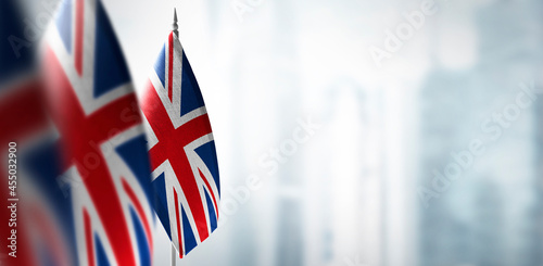 Small flags of United Kingdom on a blurry background of the city