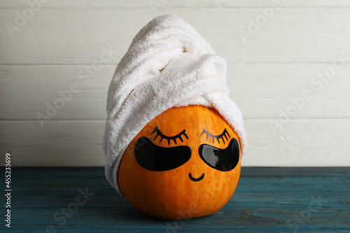Spa concept with pumpkin on wooden background
