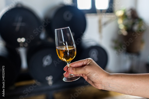 a glass of sherry wine in hand