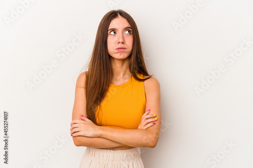 Young caucasian woman isolated on white background tired of a repetitive task.