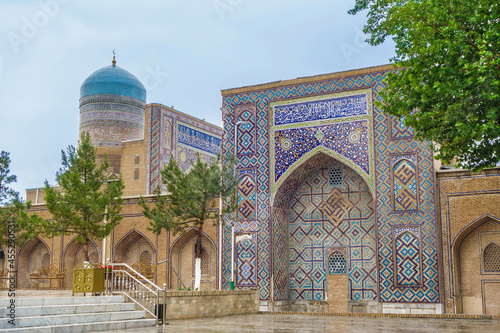 Panorama of portals of Nadir Divan-Begi madrasah in Samarkand, Uzbekistan. Also visible is traditional blue dome with crescent moon. Founded in 15th century