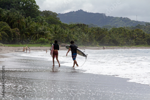 Surfing couple in Samara, Costa Rica
