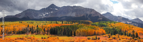 Panoramic view of Wilson peak in Colorado surrounded by Fall foliage in autumn time