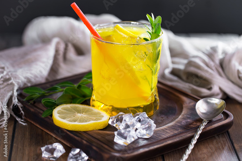 Fruit cocktail, in a glass with natural healthy fruits on a table with kitchen accessories.