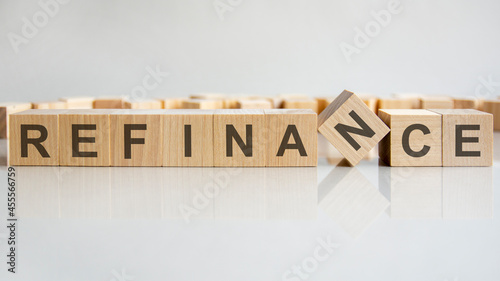 word refinance on wooden cubes, gray background