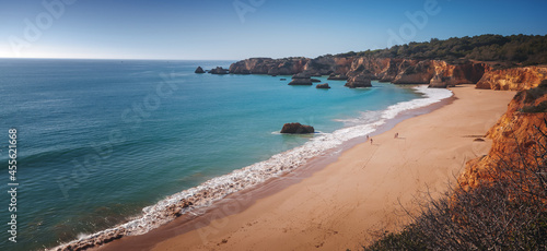 Atlantic coast in Algarve, Portugal. Beautiful bright landscape, waves and rocks on the beach