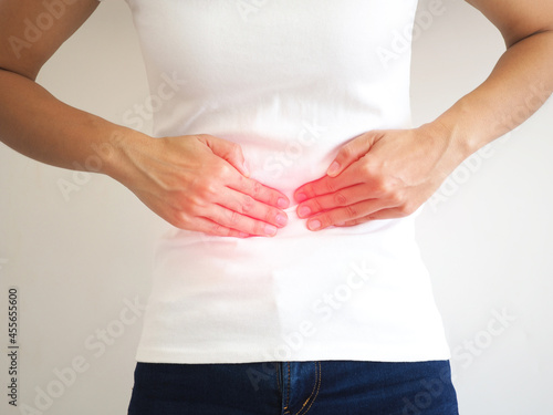 Woman with stomach pain causes of abdominal pain include inflammatory bowel disease-IBD. stomach ulcer irritable bowel syndrome (IBS), ulcerative colitis and microvilli. closeup photo, blurred.