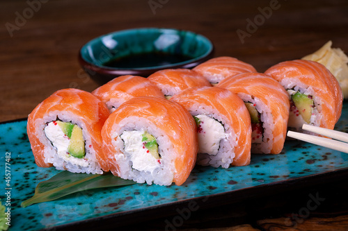 Sushi set with red fish on the table on blue dishes