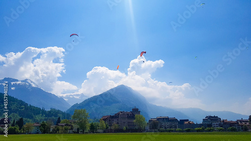 Bright blue sky filled with colourful paragliders in Interlaken,Switzerland