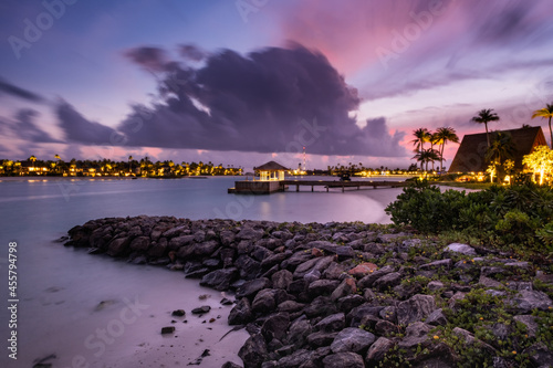 Palm trees on tropical coast at sunset. Crossroads Maldives, hard rock hotel, june 2021. Long exposure picture