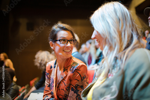 Businesswomen talking in conference audience